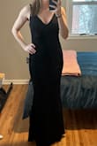 This is a great basic black dress. It's classy and has a beautiful mermaid shape. And it's long enough for me to wear heels with! Wrinkle free, and stretchy! I only gave it 4 stars because the material is pretty unforgiving. (See photo) I'll have to wear shapewear with it because it shows every detail of my midsection. But that is probably just what you get with a more cost effective dress. Overall I would recommend this one! - Megan D.