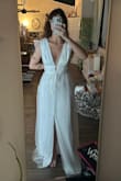This dress was pretty and better quality than I expected. Unfortunately, it fit me like a medium instead of a small. I'm holding a handful of material behind my back in this pic. I would have wore it to my reception if it wasn't for the size! - Caitlyn M.