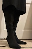 I am a 6, but ordered a 6.5 based on reviews saying the boots ran small. I bought these on sale for like $15 meaning they were final sale with no exchanges, so I figured it was safer to size up a little than be unable to fit them at all. I disagree with reviewers who found this shoe too small, as a 6.5 is roomy on me (no big deal, for $15 I will just wear thick socks). However, the top of the boot that goes over the knee is crazy wide. I am a very skinny person with equally skinny legs, so that's just my perspective. I bought these to wear under long skirts for office wear, so it doesn't bother me that much because it can't be seen. I LOVE how these boots look, though I feel the pointy toe elongates the boot where, coupled with being a half size bigger than I normally wear, the boot looks a little bit like a clown shoe that is too long for my foot. Again, for $15 I'll just deal with it, but if I were to order in another color, I would order my normal size. - Emily K.