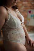 I bought this bodysuit in a size L for a boudoir shoot and it was my favorite piece! It fit true to size and I felt very comfortable in it. The crotch is a snap closure and was not uncomfortable like I was worried about. There is no underwire, but a thicker seam. The all-lace back scoops a little in the back and is a thong. I was very particular while shopping for a piece, not wanting anything too revealing but also wanting to "leave room for imagination" and this was it.
AJS Photos and More in Indiana, USA - Andrea B.