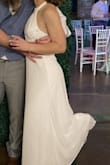 I wore this dress for my wedding reception and absolutely loved it! The style is stunning, but the fit was very large on me, despite ordering the XS. The halter at the neck was way too long and had to be taken in a lot, and the bodice was rather loose. Still love this dress, and if you are willing to alter it, I'd definitely recommend! - Elizabeth H.