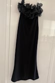 The dress fits perfectly to the body. It is tight and long but does not drag. The most beautiful part of the dress is the flare of the chest. It looks super elegant and balances the bottom part of the dress. It also has a back opening that allows you to walk without any problem. Good quality fabric. Without a doubt, an excellent purchase. - Ninoska P.