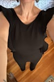 This jumpsuit is really cute, and the ruffles seal the deal. In most brands, I wear XS or S, but according to the sizing chart, I ordered a medium. This was slightly loose (everywhere besides my chest/ribs), but I think a medium is probably the correct size for me since I wouldn't want this tight. It is a bit long for a shorty like me, and unless I wear it with a significant heel, it drags on the ground. The fabric was thinner and less structured that I imagined. This is flattering, and I have gotten comments on how cute it is both times I've worn it (to a bday party and to work). - Phanie B.