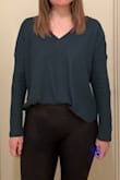 I like the deep forest green shade of this top. It feels more like a top than a sweater. It does not feel soft like a blanket (it's not scratchy or rough, it's just not a plush cozy kind of knit). I think it looks cutest with the V pointed as far down as possible. When the V falls too high, the neckline isn't as flattering (on me, anyway) as it is with a low drop. I will probably always tuck it up into my jeans for a more crop fitted hem - the natural hem line is quite long and curved. The arms are the tiniest bit tight around my shoulders but I wouldn't change sizing. I ordered my typical size. Also, the ribbing isn't very obvious in the model photos but it's very obvious in person. It's definitely a rib knit. Again, the color's really pretty, especially if you look best in "Autumn" shades. - Katy M.