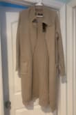 The cardigan is a much darker color in person. The online picture is more beige. - Tori F.