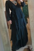 A lovely wrap style dress that shows some leg. I really like the ruffling on the bottom, I think it's flattering. The color is lovely. The chest is pretty open compared to other wrap dresses I've worn. Long and will need to be hemmed. Really happy with my purchase. - Allyson W.