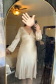 I know the material is not made to stretch but I couldn't even raise my arms without it feel like it would break at the seams. I do feel like if I sized up it may have been too big in the arms/sleeves since they are more baggy but around the stomach was snug and the shoulders. - Emma T.