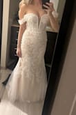 The dress was true to size and fit me well. I am normally about a 4 to 6 and I went with a four. This dress does not have a lot of stretch or give. Maybe a little bit in the hips. It definitely has more of a nude undertone from the waist down with the tulle. A beautiful dress, especially for the price, but I was looking for more of a white wedding dress& with a small train. I am 5'6" and with heels, the dress swept the floor perfectly. I I will likely keep this as a back up until the dress I chose has gone through alterations. - Nicole I.