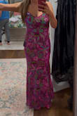 I'm often between a small and a medium. Every time I order a medium, I end up thinking I should've gone with a small. I have a relatively large rib cage for my height, so I was a little worried when I first put on the small. It felt like it wasn't going to fit! But thanks to the stretch in the fabric, it ended up fitting beautifully. The gown itself is stunning, and the quality is great. Also, the shipping was insanely fast! It literally arrived the next day! Overall, I'm really happy with my purchase. If you're in between sizes, keep in mind that the dress has some stretch so sizing down might work better. - Morgan A.