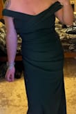 This is a gorgeous elegant dress! I was cursed with large shoulders and slim hips so this style doesn't usually work for me. But the layering of the dress in the front along with the shape made me look slim and curvy. It frames my body so well without being restrictive and it hugs all the right places. I would order true to size if you want a snug fit and size up if you want more wiggle room. 

The slit up the side adds some sexy and the off the shoulder is so cute. - Haley B.