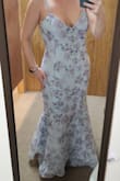 I was excited and wanted to love this dress, but I feel like it is a "doable/okay" instead. I ordered a large but accidentally received a XL. However, I am glad I did, I don't know if the large would have fit. I did have to get it taken in the bust and hemmed in the front to be wearable to my event. It was extremely long- this picture is with the light blue heels on that the model is wearing. - Brooklynn L.