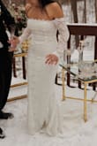 I absolutely loved my wedding dress! It fit perfectly and made me feel stunning on my special day. The fabric, detailing, and overall design were just beautiful. I felt so elegant and confident throughout the day. The only minor issue I encountered was that it was a bit difficult to move my arms comfortably, but honestly, it was such a small thing compared to how amazing the dress made me feel. I would highly recommend this dress to anyone looking for a gorgeous and flattering gown for their big day! - KAREN P.