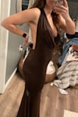 The dress looks just like the pictures and the other reviews. The size robot told me I'm a large, but the large is too big. The medium fit perfectly.  I'm a 29 in jeans and an 8 in yogas/ dress pants. The brown dress is a size large and you can see it. It's big in the back. The red dress is a medium. It does hug your curves so if you don't want something that highlights your belly from the side, this might not be for you. The larger the dress was the longer the front hung down as well. - Katie O.