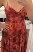 It's a beautiful dress. Love the flowiness of the skirt, and love that you can wear it without a bra. Very flattering shape even if you carry a little extra in the lower tummy. I'm usually between a S and a M, went with a M after reading reviews and I could barely zip it. I probably should've gotten a L. The color of the dress wasn't as pink/red as the model picture, the one I got was a lot more orange in person. And I knew the pattern would be a little different on this kind of dress too, but just beware little lavender spots may stand out in random places between the flowers. The dress I got had one right by my belly button and looked odd. I wanted to love it, but it was a return unfortunately. - Mary G.