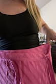 I'm usually a solid Large in most things Lulus, but this one runs a full size big. It also goes down to my fingertips for length. - Kaytlin K.