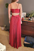 It is a nice dress, but it showed a lot more skin on my daughter's 15 year old frame than we were comfortable with.  The back sagged a bit because it was too large by a size.  Had it fit perfectly around the waist, we felt it would have fit around her in an odd place--not empire, but not at the natural waist.  She's quite tall & thin.  
The length was perfect.  The material was nice.  The photo color is true, but we expected more red, less magenta.  The back has a gold zipper that was a nice detail, we thought.  
Ultimately we returned it due to the fit.  We really wanted to love it. - Meredith R.