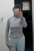 I'm usually a size M, but I decided to order a size L this time. I was surprised to find that the blouse was still short at the waist level. It was unexpected that the blouse runs small even in size L. I can't lift my arms because ended up showing my belly! However, I love turtlenecks, and I really like Lulus. - Tatiana B.