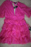 It looks nothing like the picture. The color is not the same as online at all. It's like a deep magenta in person. It was crammed into a bag so the tulle is all bunched up. I was saving it for vacation and sadly missed the return date by just a few days. This is a large. It is huge on me but extremely short. - Harmony T.