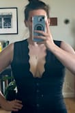 LOVE this top! It runs a bit small, I'm a L in all the Lulus dresses I tried on but sized up to an XL for this because of my chest size, and thankfully I did, as it was snug through my midsection as well, but in a great way. The top holds you in - so to my fellow large-chested girlies out there, this is a miracle worker. You can wear it with a real bra, but even without it, the width of the scalloped top really holds you in and I felt secure but not smushed. Also, the buttons have zero gaping or pull, laying flat. 

I will say, the buttons can be kind of difficult to button, just small and kind of slippery, but once they're buttoned they stay. - Megan E.