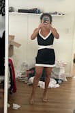 Dress is very cute! It has minimal stretch though. The XS fit, but it was a little tight on my back. I could remove my bra and would fit better. It is short but perfect length for petite frames like me. The stitching to the V-neck has some imperfections that are noticeable, so I'm going to return mine. - RISS R.