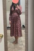 This dress is of very good quality. It's kind of like a satiny/silky material which is really nice. It has a side zipper which is a little hard to use. It's got a cute keyhole and an under skirt attached, and it's not stretchy at all so be careful. Other than that, really nice dress and can't wait to wear it! - Debora B.