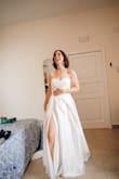 I didn't want to spend a ton on my wedding dress, and this was a great dress for an unbeatable price. It has beautiful layers, a nice feel, and a flattering shape. Like others, I had the leg slit sewn up just a bit and had it hemmed, taken in a little, and added a bustle. The only place where it feels like a budget dress is with the simple zipper close in the back - I wish it had some buttons added to make it feel a little more elegant back there. But overall, 5 stars for me! - Julia K.