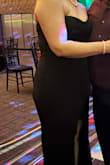 I ordered this dress in a Large, my usual size from Lulus, but could not even zip it up! It was extremely tight and the slit was very high! I exchanged it for an XL which came in time for my work event. The XL fit OK but the bodice was a little bigger than I needed and the cups are definitely not for anyone larger than a A or B cup. In the picture, it looks like the slit is on the side but the actual dress is right up the middle. Thankfully the all black material and stitching camouflaged the small cups, and having to size up provided a little more coverage on my legs. The material has a little stretch to it but the zipper was flimsy and I had to iron the whole thing before wearing it. Overall it wasn't a bad choice for the sale price, but I wish I had looked a little more snatched when I saw our pictures. If you're curvy you probably need to size up. - Corinne L.