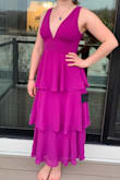 The dress is exactly as pictured! I ordered the purple, please note my camera did not capture the true color of the dress so it looks more pink/red, the true color of the dress is much more like the Lulus images.
The dress runs a little small, I ordered a size medium which I always prefer and I usually have a little bit of extra wiggle room, but this one was a bit more snug than I'm used to, but nothing unmanageable. In the image I am wearing bra pads, the dress does have much coverage at the boobs so if you like a little more just a heads up. The dress is also a little lower cut than I was expecting, I'm not sure why I didn't expect this considering all the photos I looked at before purchasing, but I think it's one of those things where it looks great on other people but on you, it feels more revealing because it's yourself!
Overall, I would definitely recommend the dress, it has modest coverage for the legs/butt, but a little bit more skin up top, which is a great balance and great for a wedding. - Grace A.