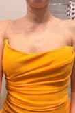 The top folds in on itself, and the lining hangs out the top. It's also crooked and bent at the top. So sad. The color is pretty. There was also a weird spot on the top. - Samantha H.