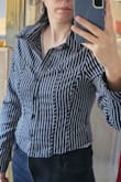 It's cute, but it is very tight.  No stretch at all.  It works for me even with it being so short, but I have a small bust. I would definitely go a size out two up, and the cut and design look really nice on me,  but I don't think it's for everyone. - Anna C.