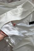 The design of this blazer-style cape is interesting, but it has some drawbacks. The back is not fully closed, leaving gaps on the sides that let cold air in. The fabric is decent, but it could be of better quality. It has a more casual feel than expected. The shoulder pads are too bulky, making the fit look and feel awkward. While the item was delivered on time, for the price, I expected something more polished and practical. - Paulina M.