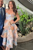I received so many compliments on this dress!! It was slightly tight for me in the rib area but not to the point I was uncomfortable. I decided to tie the straps halter style instead of in bows to feel extra support without a bra and I really preferred how that looked on me! 10/10 dress!! - Erica Z.