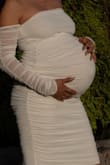 Used this dress for my maternity shoot. The fabric is perfect for the amount of give necessary for my 34 week pregnant belly! I'm petite and have a very "out there" bump, and it was super comfy. The sleeves were a dainty touch that really brought the look together. I was so happy with it. It is easily smudged, tho and the mesh makes it hard to come out in a pinch. My toddler got it smudged pretty quickly after the shoot started, but actually could mess with the folds in the mesh to hide it. If you're looking to accentuate your bump without the hassle of the flowy gowns (also just not my style), this dress is perfect!! - Amelia R.