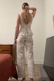 I bought this for my wedding weekend. It's super cute but the fit is a little off. I am 5'10, 135lbs, bust 32.5" (34A), waist 26.5-27", hips 37". The XS was too small in the waist/ribcage, but the S is massive in the bust. I could fit DDs in here easily. The waist in the small fits well and the hips have a little room. I will have to get the bust tailored at the two seams by 3-4" for it to lay flat and also prevent the straps from falling. The legs are quite short on me as well but I expected that as I am 5'10 with a 34" inseam. I still think it looks cute cropped. The zipper also gets stuck at the point on the back where the peplum splits for some reason. - Nicole W.
