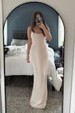 Wore this dress to my engagement shoot and absolutely loved how it looked in the photos! It's simple, timeless, and classy. We only got a few sneak peeks back so far that highlighted the back, but I absolutely loved the simple tie-up detail and how it draped in front. You will need to get it hemmed if you're 5'5 or shorter since it is a little long, and a stick-on bra. This is the perfect dress for any classy occasion, but note that it is an ivory/champagne color. - Leilani M.