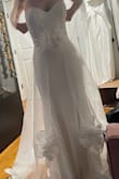 I bought this for fun, thinking I'd return it but but I actually think this is the dress I'm going to go with! It fits perfectly. It's comfortable. I love the overlay! It did come ripped, but customer service is very helpful. - Andrea L.