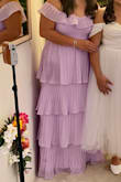 I loved this dress!  I got compliments from other guests.  It's fancy but also very comfortable.  It has a silicone strip sewn into the top so it does the dress stays up. Since it was delivered folded up in a bag, it was wrinkled, and I had to lightly steam it.  Don't iron it because you can lose the pleats.  The bride and groom requested that we wear lilac, and it was the perfect shade. - Doris C.