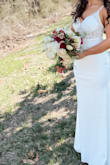 This dress looks exactly like the photo and better! The train is very long and a bit heavy, so I had that altered since I will be doing a lot of walking. This dress fit perfect and the price is unbeatable. So glad I chose this for my wedding!! - Tay C.