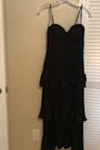 This gorgeous dress was exactly what I wanted for a black tie optional wedding in Florida. I am between an XS and a small size, and wasn't sure which to get. The small is a little loose, but still fits and is so comfortable. The XS fits, but was tight when I took a big breath, so that is why I kept the small. Love that you don't need a bra with it. The tiered layered skirt and the beautiful design of the bodice make it very unique. The zipper is a bit fussy sometimes, but other than that, it is perfect! - Sally K.