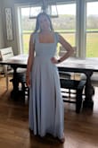 Purchased this dress for my bridesmaids dress in an upcoming wedding. It is the perfect shade of light blue. It does come very long, which is good for the tall girlies who need it, but I took it to get altered and it was an quick and easy fix. Probably took about 3-4 inches off and I am 5'5 to make it floor length with my 1.5 inch heels if that helps! I typically buy a small, but after reading other reviews for bustier girls to size up I got a medium. I am glad I did because there is no give in the bust area, so definitely size up if you are larger up top! The pictures I added are after getting the length altered. - Kylie Y.