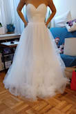I love my dress. There is certainly room for improvement and this is why it gets 4 stars. The flowers are gorgeous and you can certainly appreciate the detail. The material used to tie the back of the dress is also tulle which isn't strong. The dress has 5 layers and all are very pretty. I am on the shorter side so I am going to add boning or wire at the bottom so I don't trip when walking. I hope to upload more pics when I get help putting the dress on. Edit to original review: I wanted to offer advice for anyone needing alterations. I am 5'3" and the dress is definitely long. I am wearing 4 in heels to help but I also needed to add horsehair braid at the bottom to keep the material from wrapping around my legs. The second and first layer of the dress were too long and the horsehair helped keep it stiff. I am adding sleeves for the ceremony. - Yuki G.