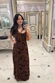 The dress is gorgeous in person. The flowers are a velvety material and illuminate sometimes when the light hits it. I did have to get the bottom hemmed. It's not a tight fitting dress but the description says that. Plan to wear again to another wedding! - Devon M.