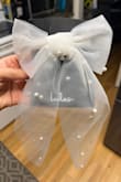 I was so excited for this to come in the mail. I planned on using it for my rehearsal dinner and maybe my reception. It looks like it was just thrown together. Four total pearls on the bow. The tail of the bow looks like it was cut very jagged and without any thought to it. The fact that I paid $29 for something that looks like I could've bought it at the dollar tree is absolutely ridiculous. - Tatiana S.