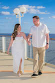 This dress was perfect! The material is stretchy which made it more comfortable than some of the other dresses I tried on. I wore the size large. I'm pear shaped and this dress was very flattering for my body type. Also, I love the flower embleshment on it. My husband and I had our wedding photos taken on a cruise ship. It was a magical day! - Kari K.