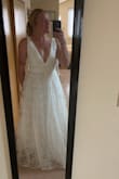This dress is very cute and great price for a wedding dress. It's a tad bit tight around my waist but nothing unbearable. I'm usually a true medium and that's what ordered. It also has two layers of tulle between the slip and the lace skirt so it puffs out. I am considering cutting this out, as I don't want a puffy dress but it works either way! - Natalie T.