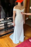 I love this dress - this is the dress that I'll be wearing for my wedding day! I love that the sleeve around the arm has grip underneath, as I did not want a droopy sleeve. I think this dress is elegant and simple, which is what I wanted. 
Alterations will be made to shorten the dress and to sew down the fabric in the middle, for some reason it sticks up, that's why the hand is holding it down in the picture. I will also be wearing SPANX underneath, as you can see the contour of my belly button under the dress. - Alice T.
