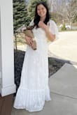 I wore this for my Bridal Shower and got a ton of compliments! I'm normally a size medium and I'd say it fit great. I'm only 5'5 and I was wearing 3.5 inch heels and it was just barely above the ground. It is more white in person compared to the photos online that give it more of a creamy/ivory look. Only complaint I did have is that it is see through in the chest area so I had to safety pin some bra pads. Very nice quality though, light and airy, perfect for a spring shower. - Hannah H.