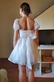 This dress made me feel like myself. So delightful and fun!! It's a little short, so I am curious how the wind at graduation will go, but I am so excited to wear this! The material is fun and shiny, and the bow in the back is AMAZING. The sleeves are very comfortable; nothing is itchy, and nothing is too tight; everything is just nice and secure. - Evangeline G.