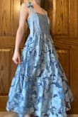 I bought this dress as a bridesmaid for a May wedding. This dress is definitely a team effort, as it's a little difficult to tie the straps yourself. On the back, it has an invisible zipper with a hook and eye, and I was happily surprised with the ease of zipping it up. The dress is a little big for me on the top, but that's mostly because I lack in the bust area lol. I sew, so it's not a big deal for me, but something to consider for my fellow flat chested gals. The inside is lined completely, and I am overall happy with the quality of this dress. The waist gather is a little itchy, but everything else is very comfortable. The bottom of the skirt hits about an inch above my ankle. The bride and I both love the dress, and I can't wait to wear it out! - Avery B.