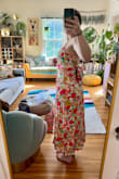 I really love this dress - so colorful and a fun back! I ordered my regular size M and it fits me well - that said I definitely have broad shoulders/back so I can see someone with small shoulders having the top run big. The dress is fully lined, but I didn't find the fabric too heavy - I think it's pretty light and flows well. I was hoping the back tie would cover a strapless bra, but it doesn't for me (at least without fabric tape/something to hold the bow in place). Overall, a great purchase for me and perfect for a summer wedding! - Summer V.